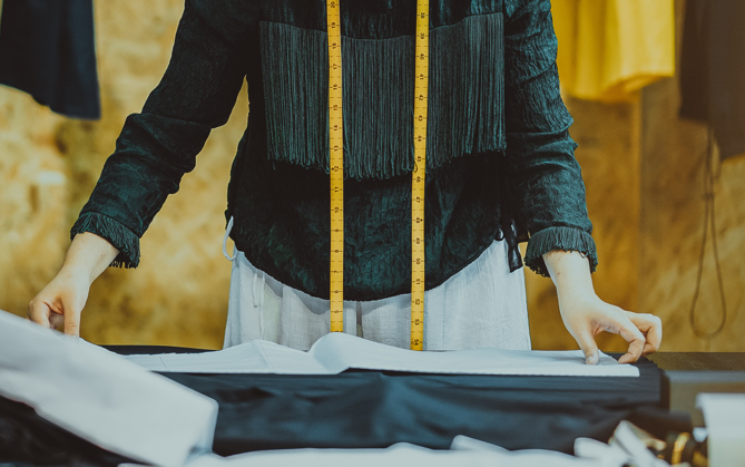 someone working on clothing on table